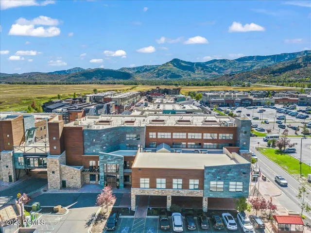 Multi-story commercial building featuring stone and wood-finish exterior accents