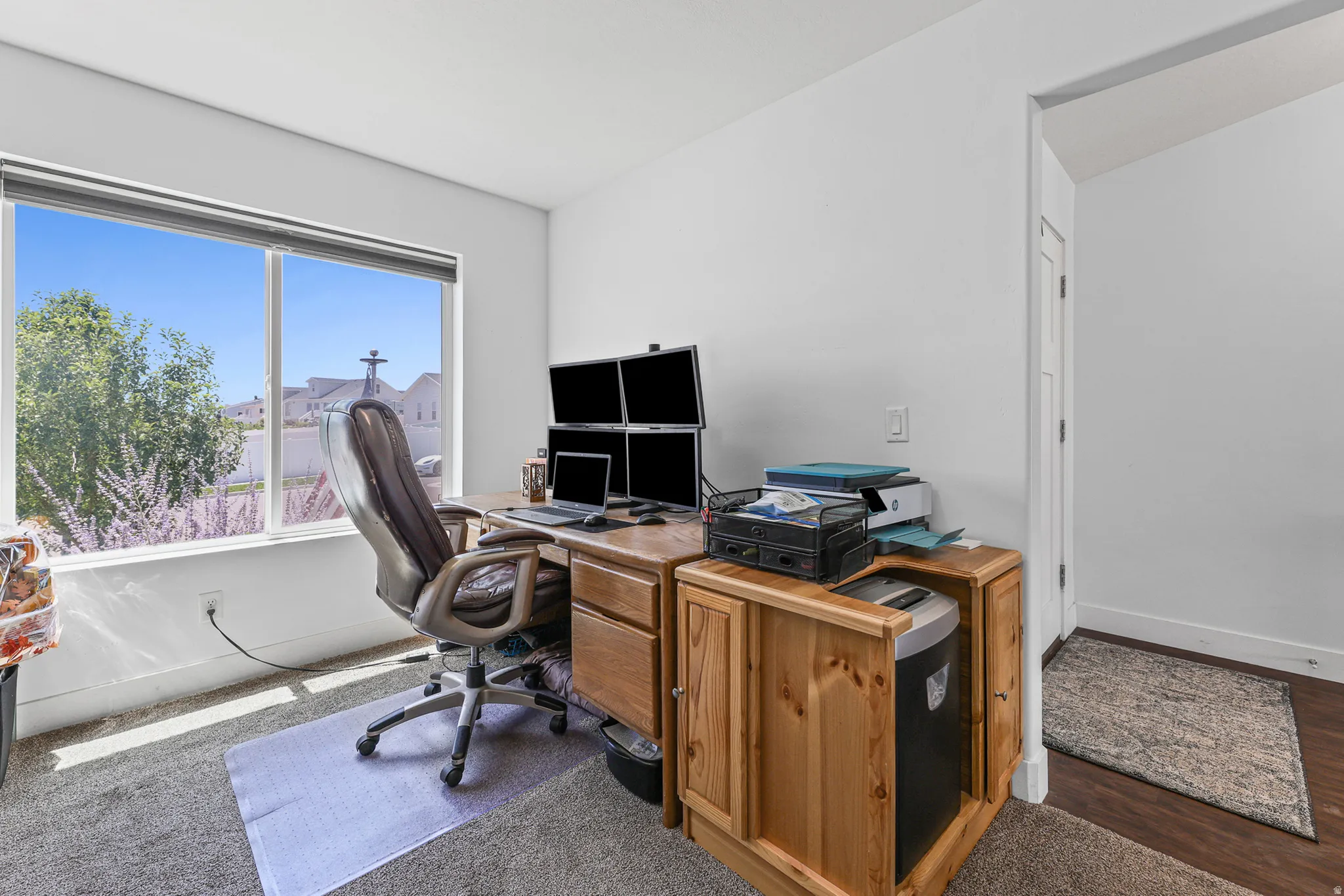 Recessed window with expansive outdoor scenery, wall-to-wall carpeting, white wall finishes, and a framed doorway