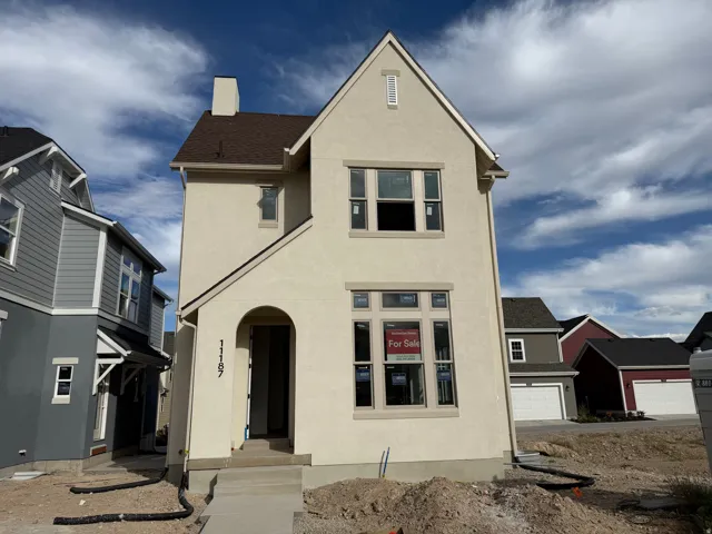 Contemporary stucco exterior with an arched entry