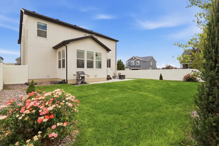 Expansive manicured lawn with a concrete patio