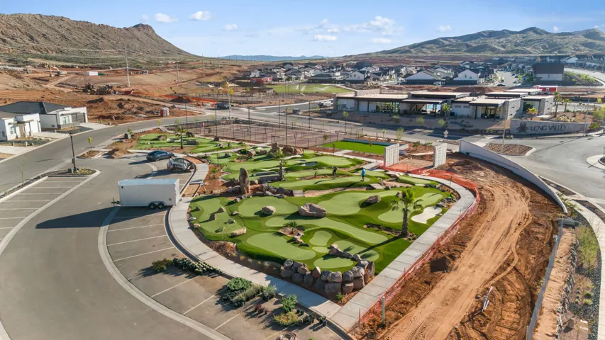 Expansive community grounds featuring a putting green, multiple tennis courts, and a contemporary clubhouse