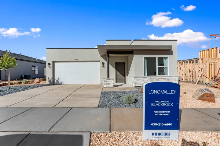 All Photos are of our model home **  Contemporary exterior with stucco finish, stone accents, attached garage, and xeriscape landscaping