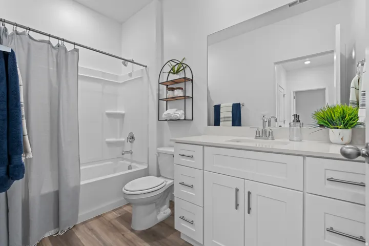 White vanity with brushed nickel hardware, integrated sink, and white countertop