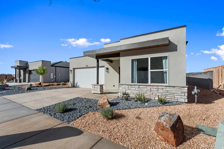 Modern exterior featuring stucco siding and a stone accent facade