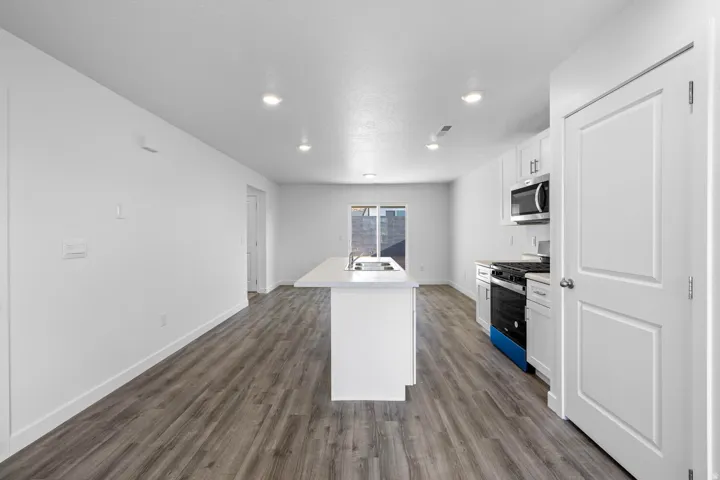 Open-concept living area with wood-finish flooring