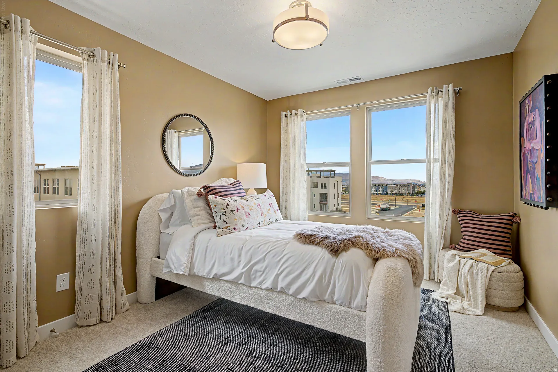 Recessed lighting, wall-to-wall carpeting, and multiple windows with roller shades