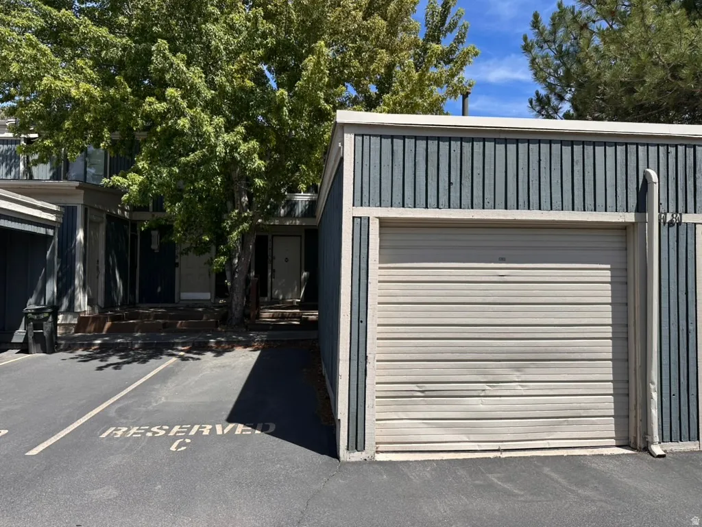 Exterior featuring 1 assigned space next to your 1 car garage, just in front of the units entrance.  Garage door is dented and perfectly operable with clicker.