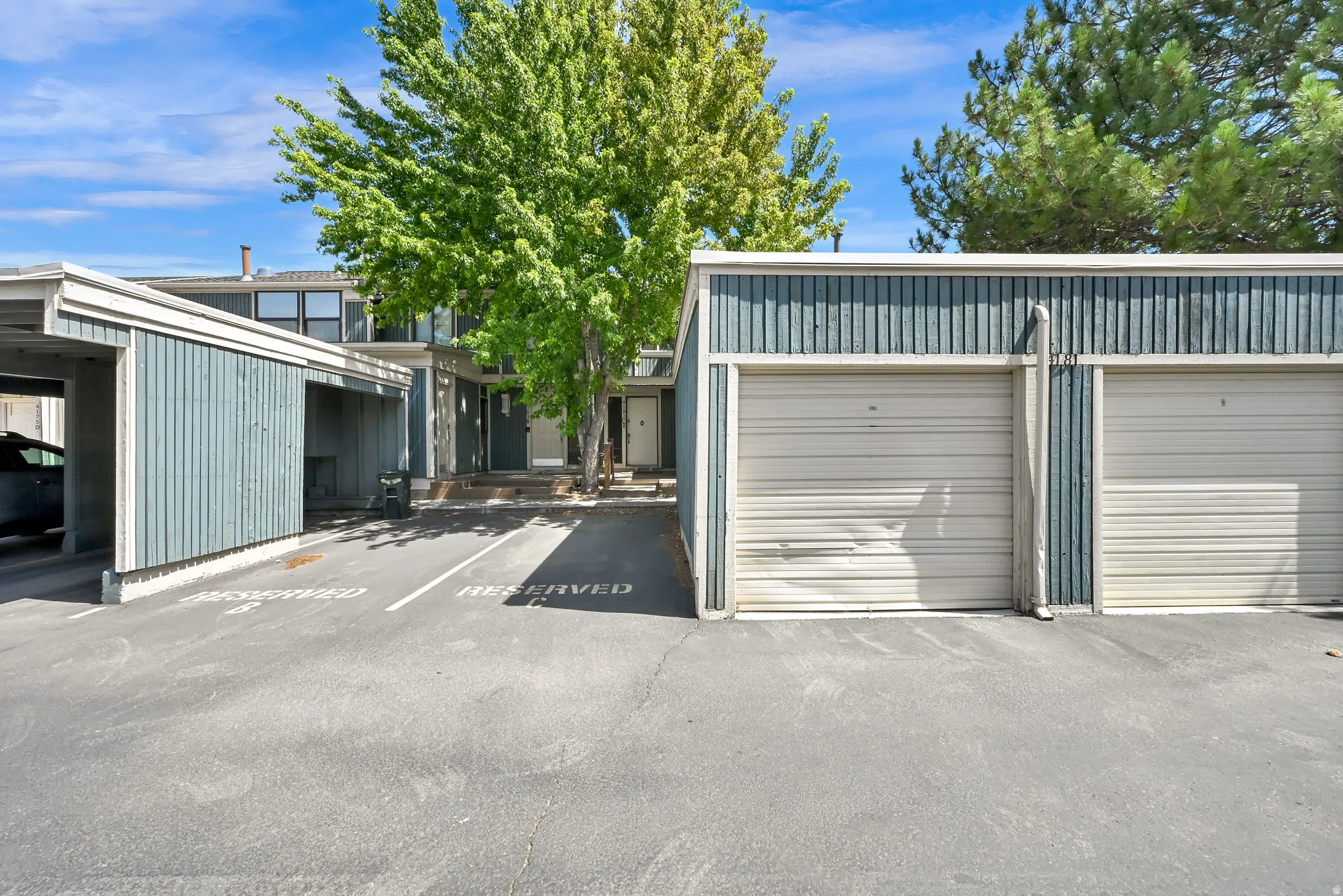 Exterior featuring 1 assigned space next to your 1 car garage, just in front of the units entrance.  Garage door is dented and perfectly operable with clicker.