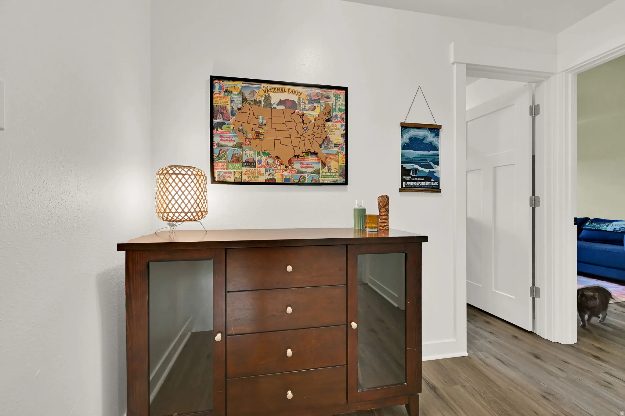 Wood-finish flooring with crisp white baseboards and walls