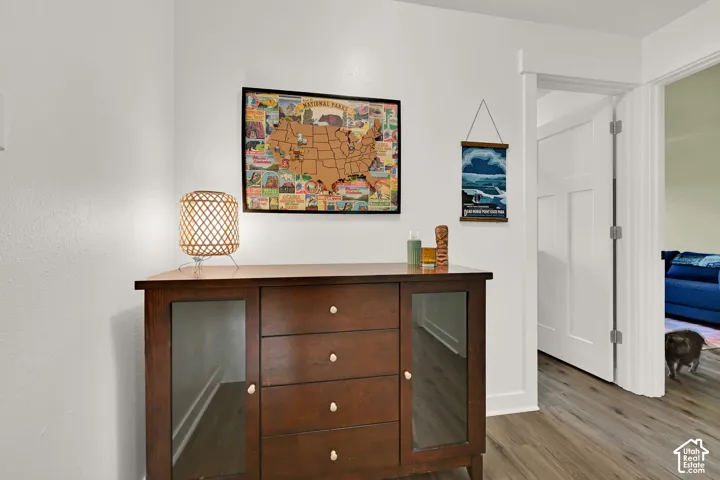 Wood-finish flooring with crisp white baseboards and walls