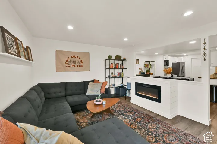 Wood-finish flooring throughout, recessed lighting, and a built-in electric fireplace