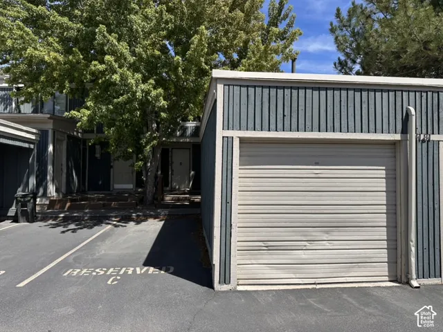 Exterior featuring 1 assigned space next to your 1 car garage, just in front of the units entrance.  Garage door is dented and perfectly operable with clicker.
