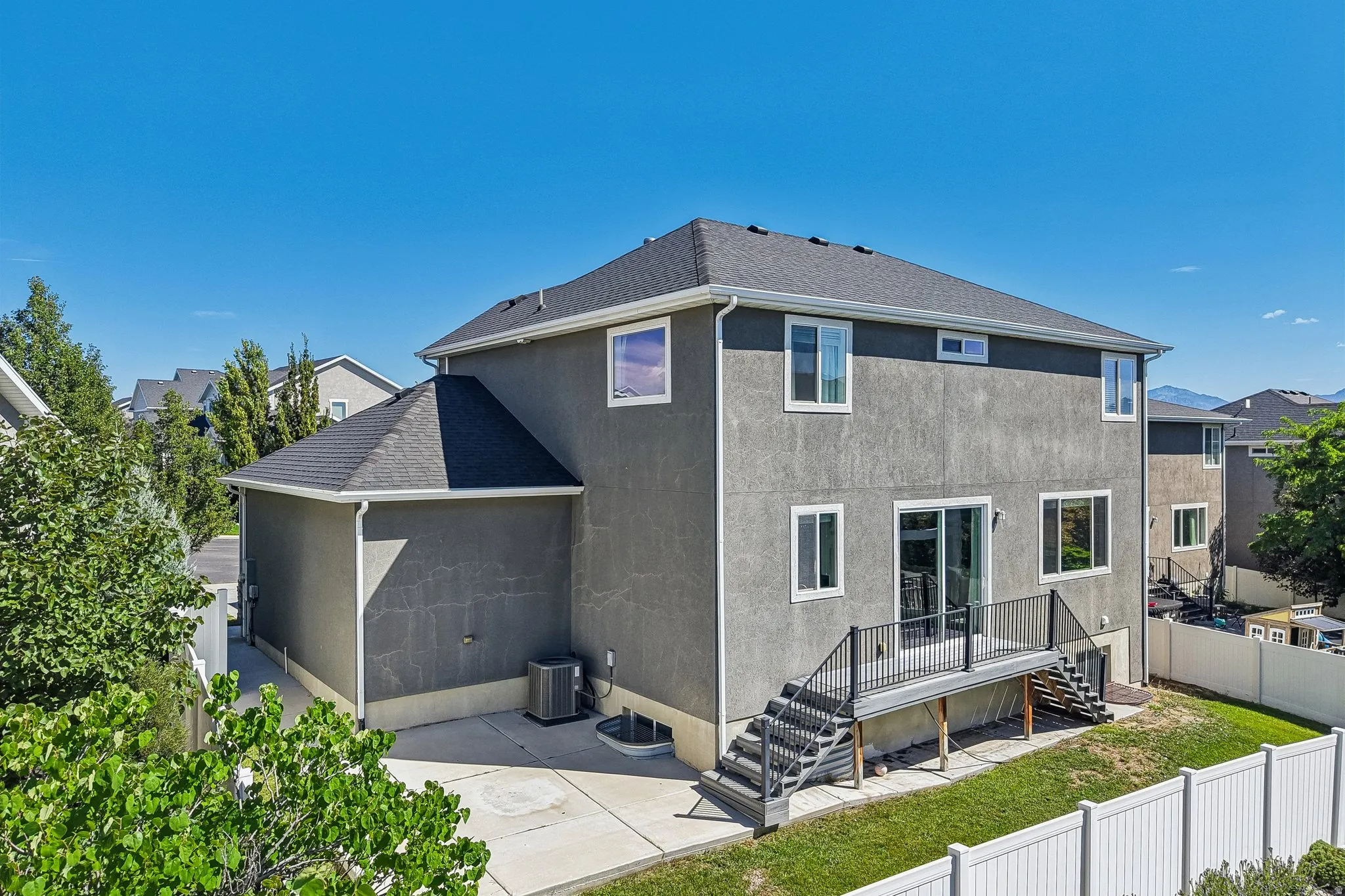 Multi-level rear exterior with gray stucco finish