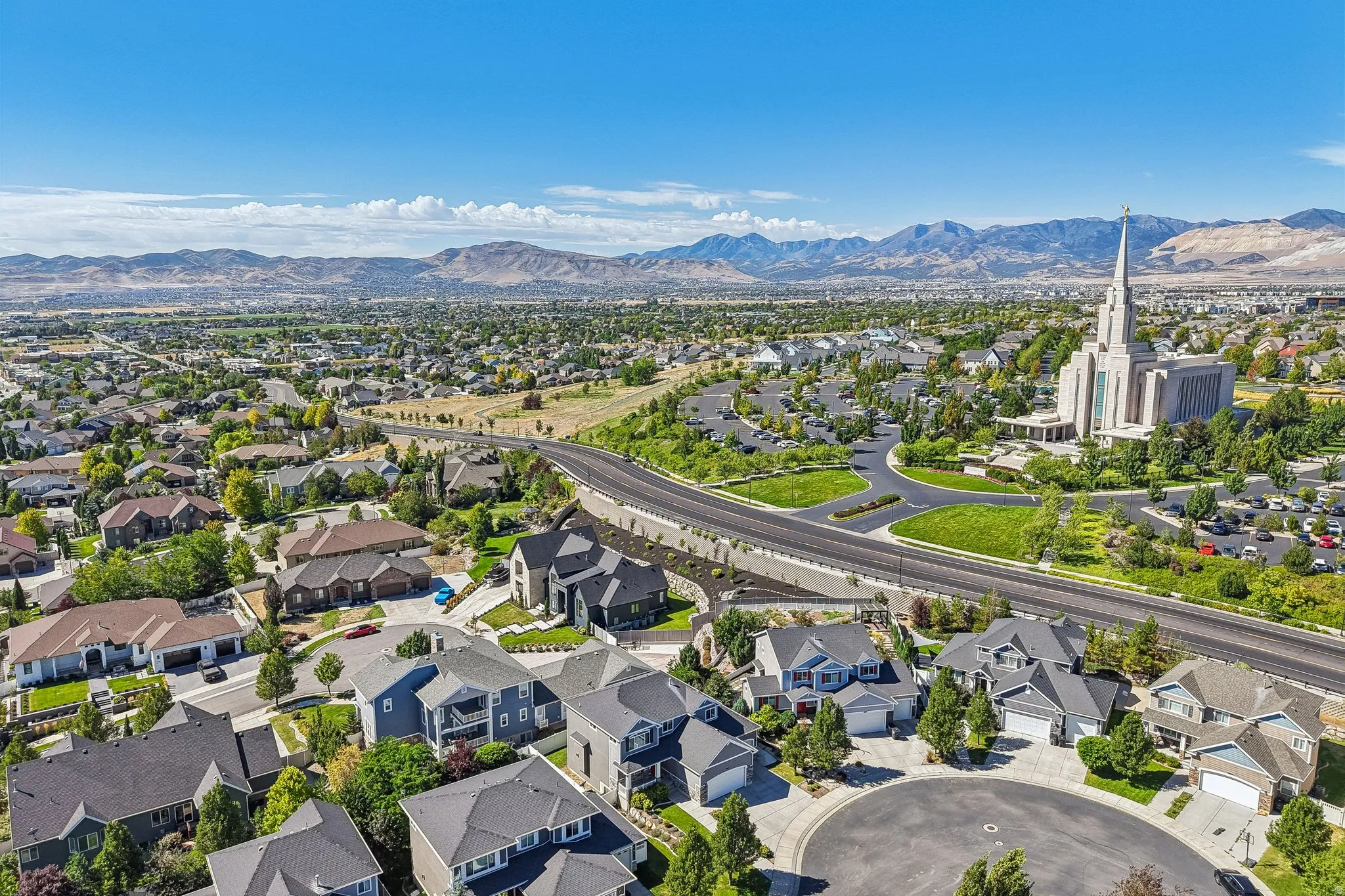 Expansive neighborhood featuring varied residential architecture, mature landscaping, and mountain backdrop