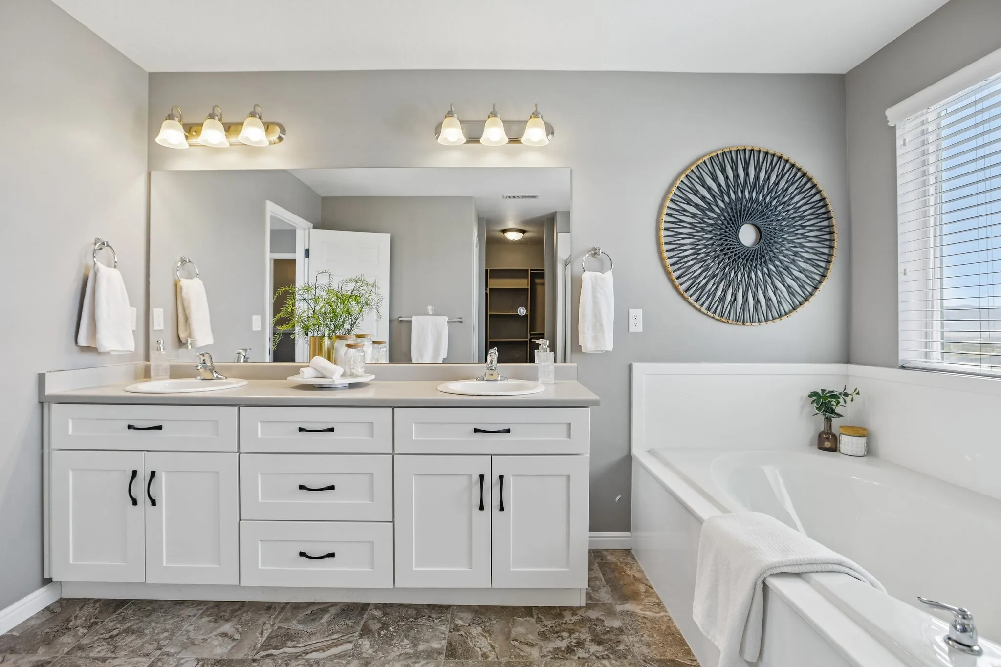 Double vanity with white cabinetry, light-toned countertop, and dual undermount sinks