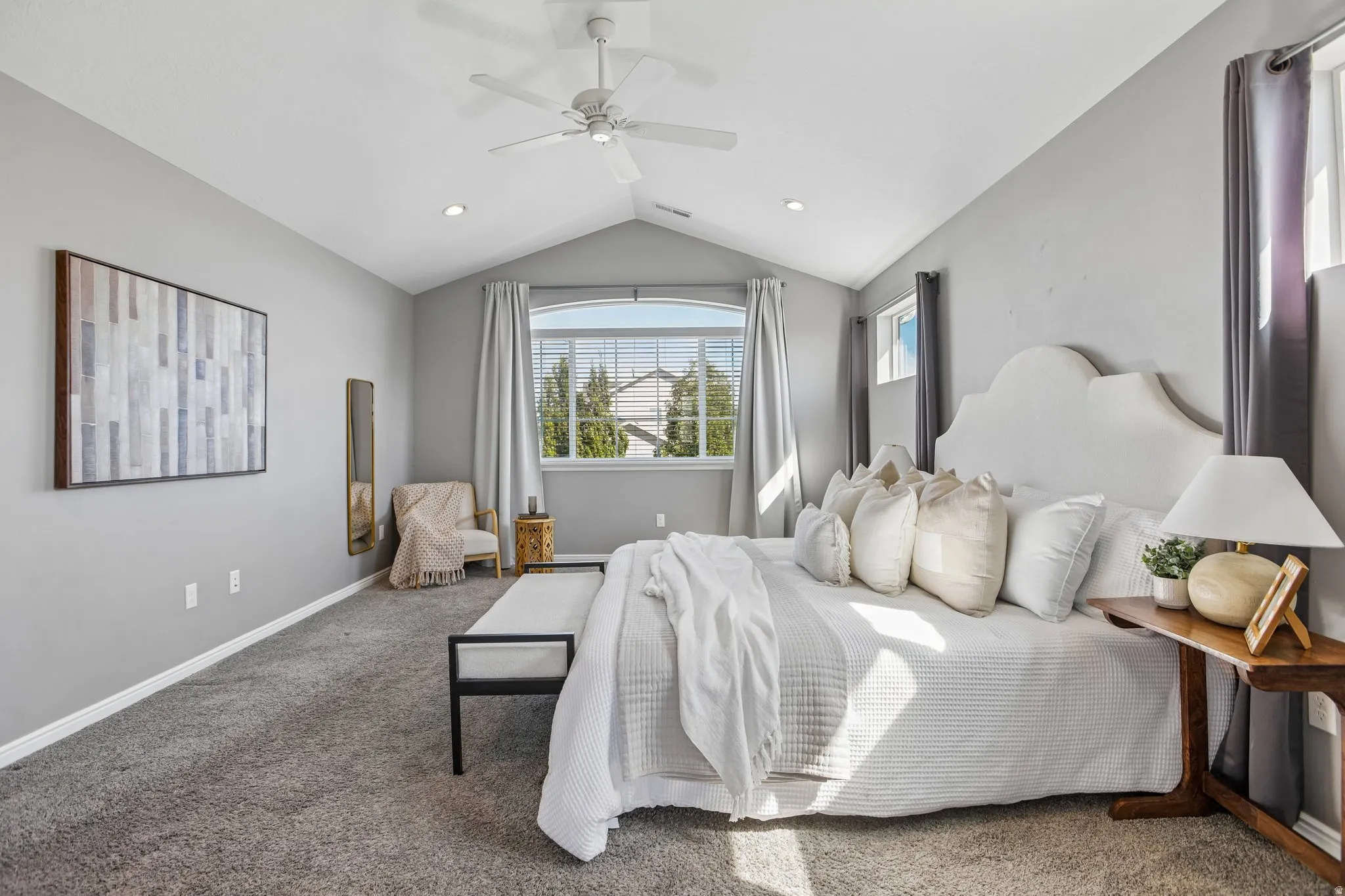Vaulted ceiling featuring a ceiling fan, recessed lighting, and soft gray carpeting