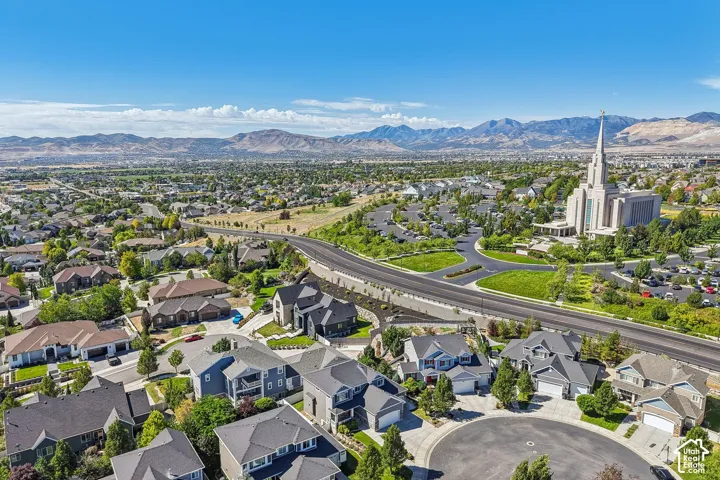 Expansive neighborhood featuring varied residential architecture, mature landscaping, and mountain backdrop
