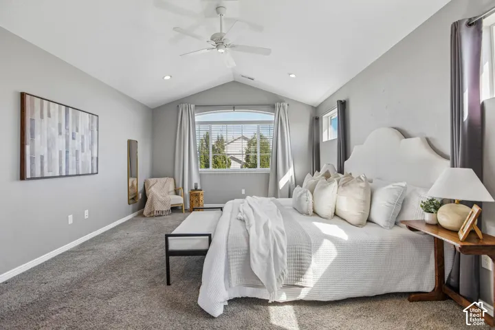 Vaulted ceiling featuring a ceiling fan, recessed lighting, and soft gray carpeting