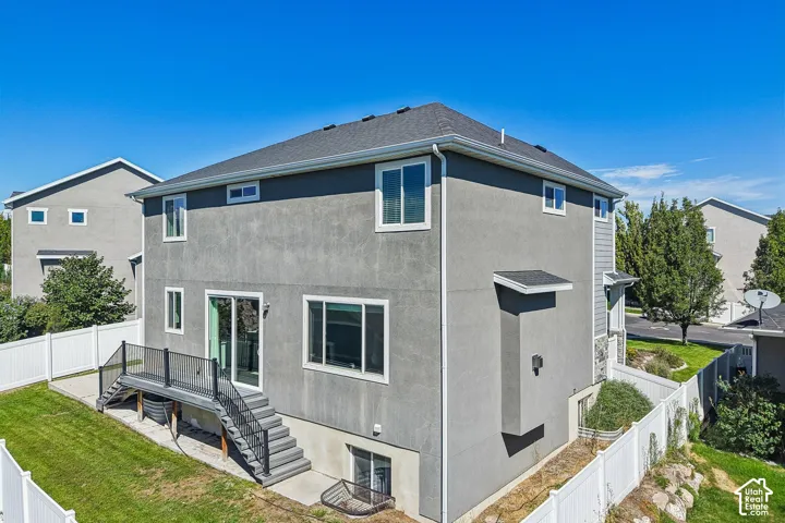 Gray stucco exterior with white trim windows