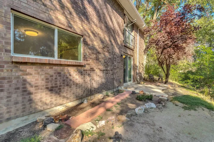 Brick exterior with a ground-level window and sliding glass door