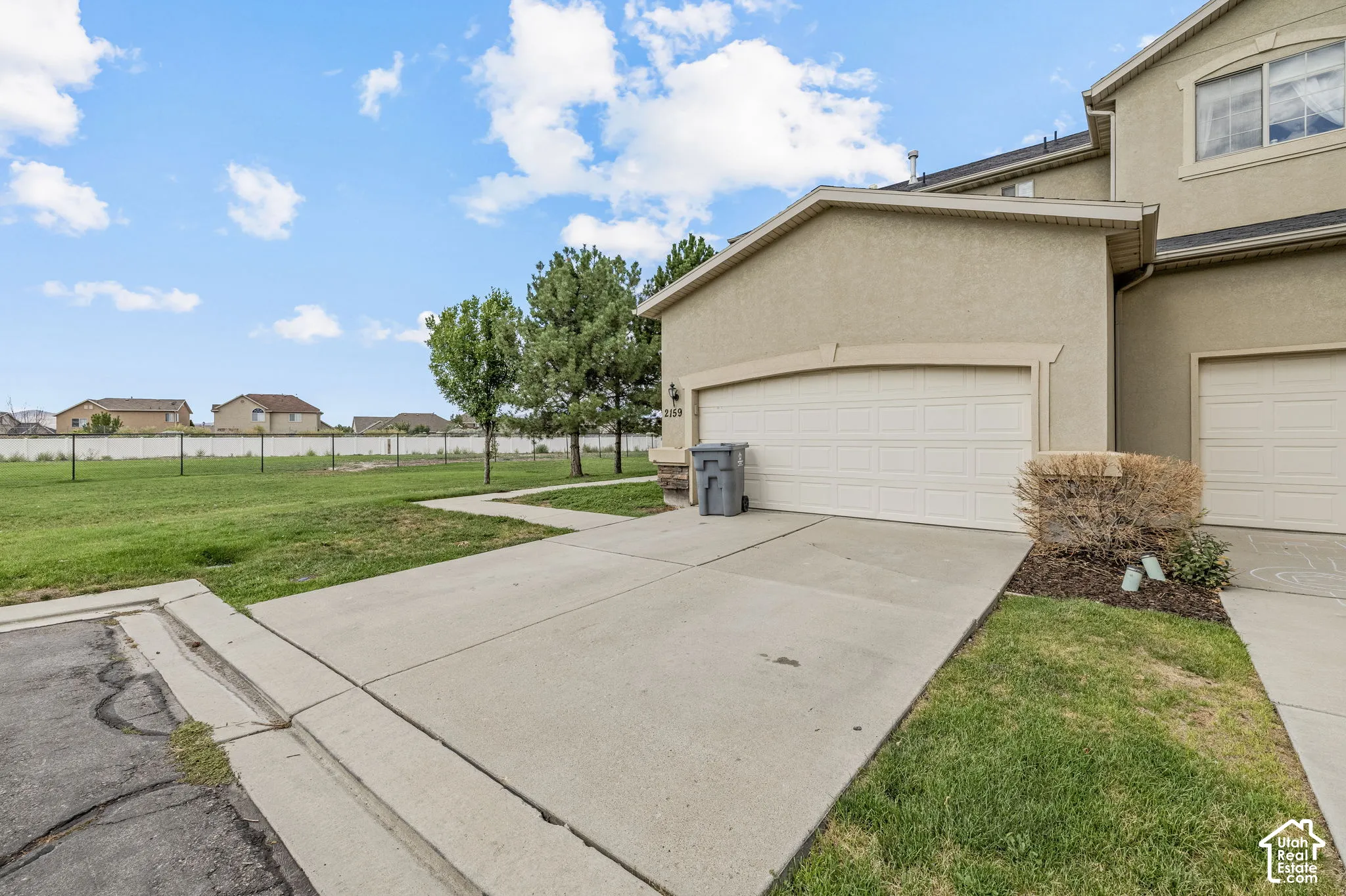 Concrete driveway leading to a two-car garage with a sectional door