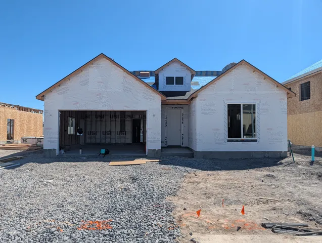 New construction residence featuring a front-facing attached garage and a multi-pitch roofline