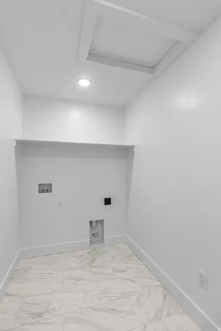 Recessed ceiling light, attic access panel, built-in shelving, and large format floor tiling