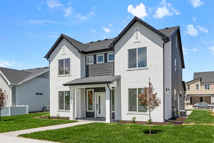 Contemporary two-story exterior with white stucco and dark gray siding