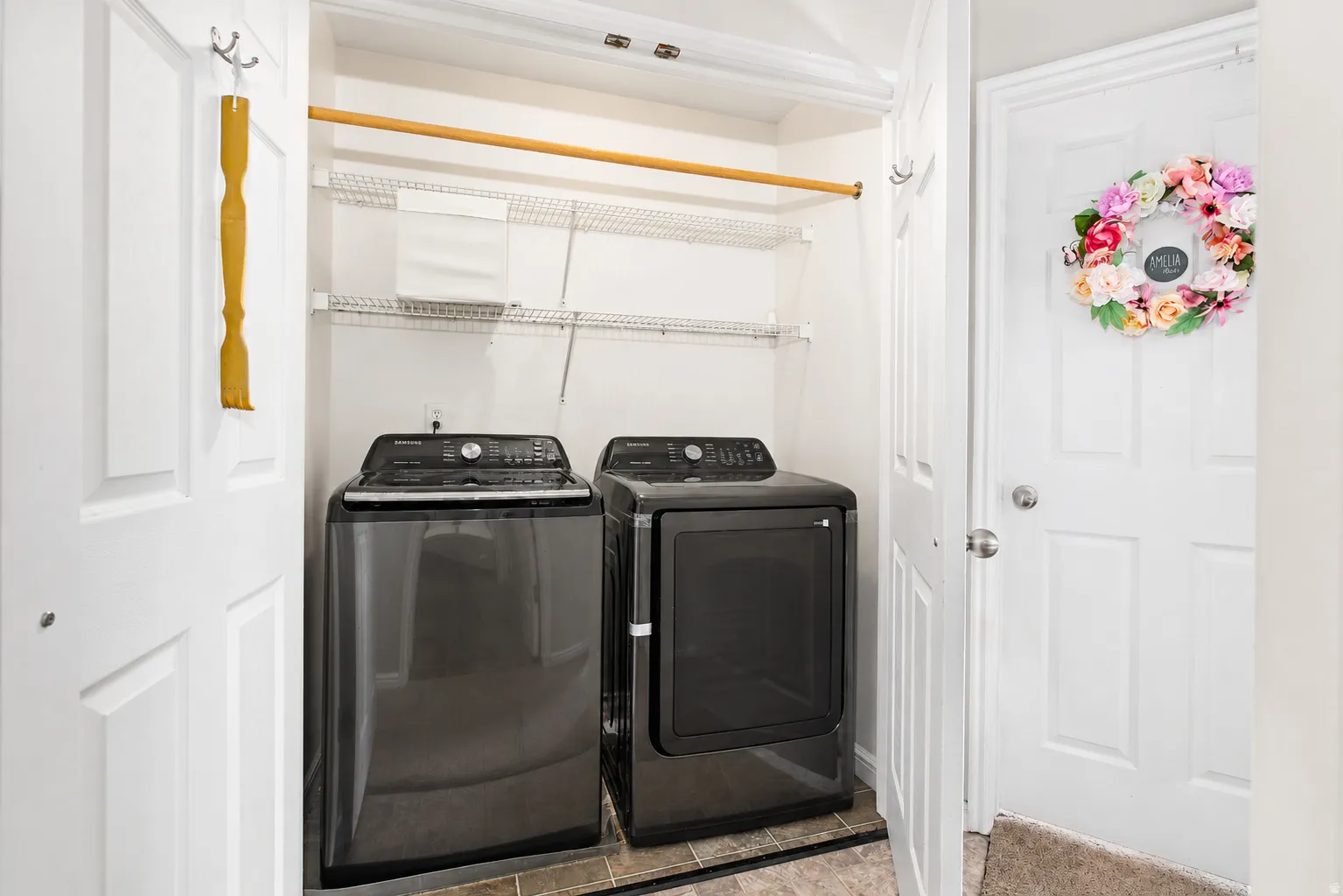 Laundry closet with wire shelving and a clothing hanging rod