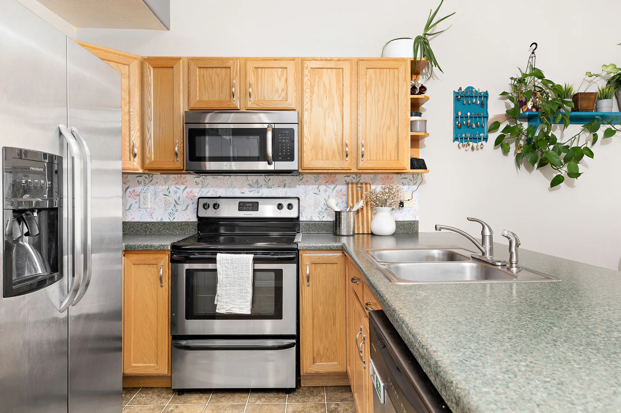 The good-sized kitchen offers ample counter and cabinet space, a pantry, spacious dining area, and a convenient peninsula breakfast bar with seating for four