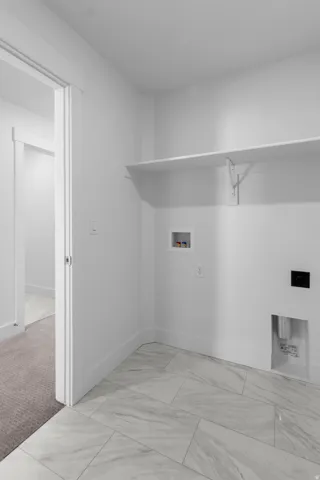 White tile flooring with a subtle gray marble-look pattern