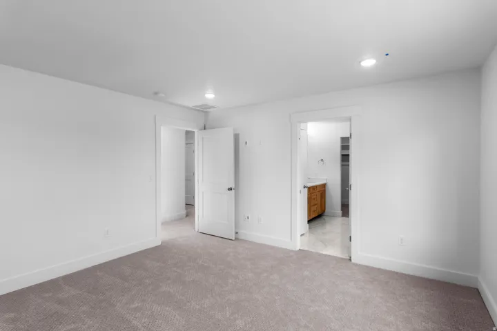 Plush carpeting, white walls, and recessed lighting