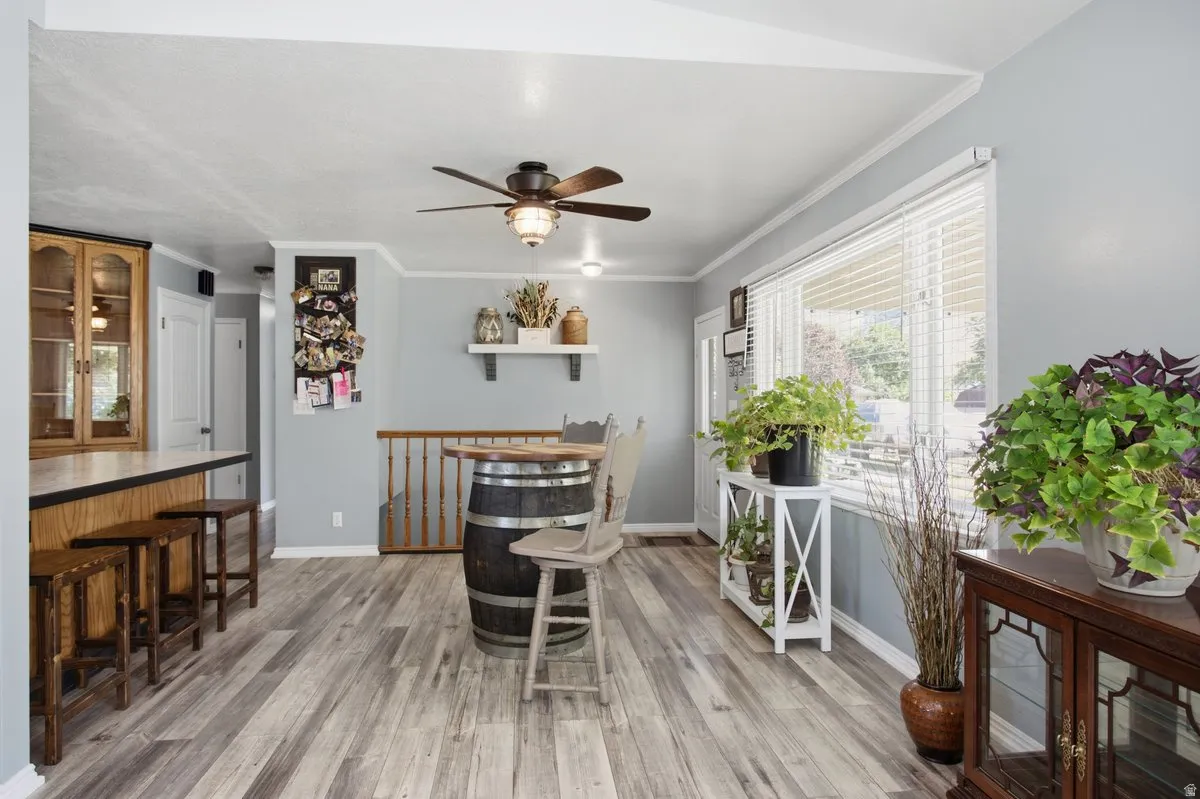 Wood-finish laminate flooring, light blue gray wall paint, and white trim throughout