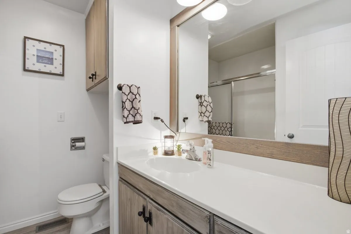 White vanity countertop with an integrated sink. Tub with shower to the left,