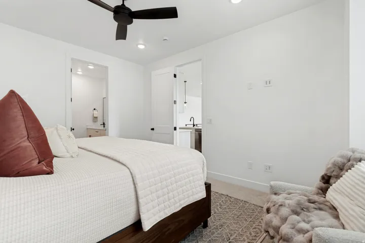 Recessed lighting, wood-finish flooring, white paneled doors, and a ceiling fan