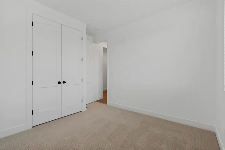 White interior walls with flat panel doors and black hardware