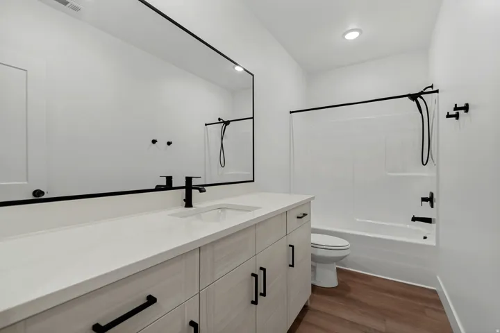 Bathroom featuring a vanity with a white countertop, undermount sink, and matte black faucet