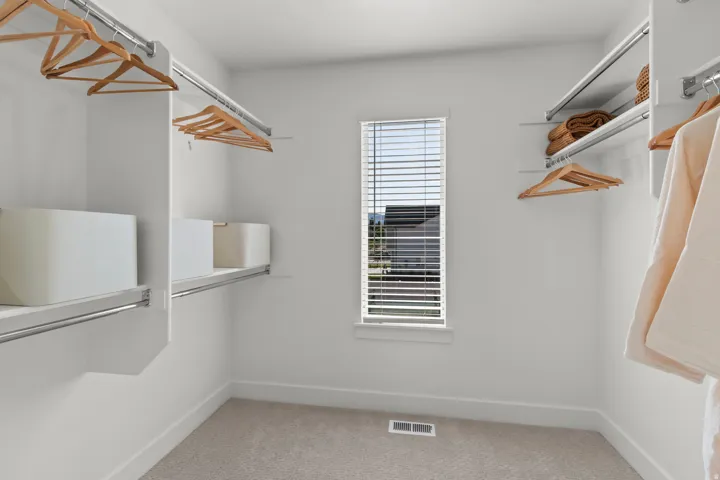 Built-in closet organization system with shelving and hanging rods