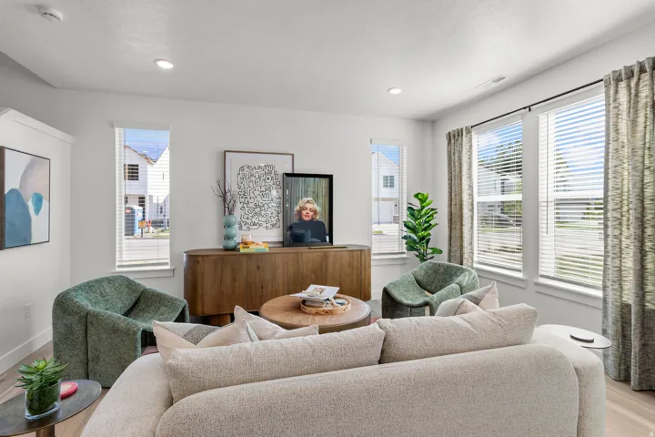 Recessed lighting illuminates the room, featuring light wood-finish flooring