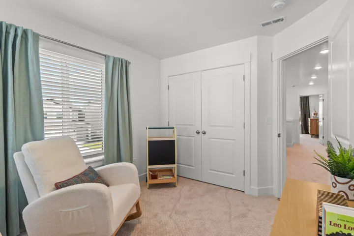 Carpeted room with white walls, a window featuring blinds, a double-door closet, and an interior doorway