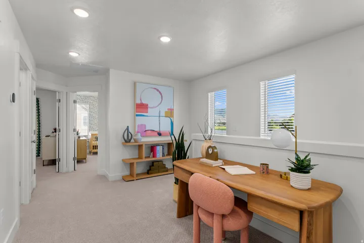 Recessed lighting, light-toned carpeting, and multiple windows with blinds