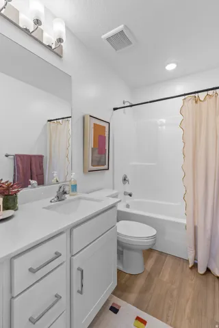 White vanity with an integrated sink, polished chrome faucet, and ample storage