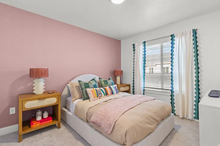Carpeted room featuring a window with blinds, recessed lighting, and a neutral color palette with an accent wall