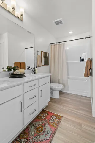 Dual vanity with white shaker-style cabinetry and brushed nickel hardware
