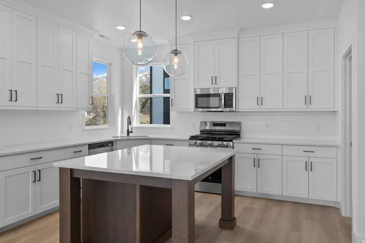 White shaker cabinetry with dark hardware