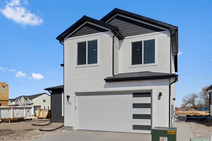 Contemporary exterior with a white stucco finish and contrasting dark siding