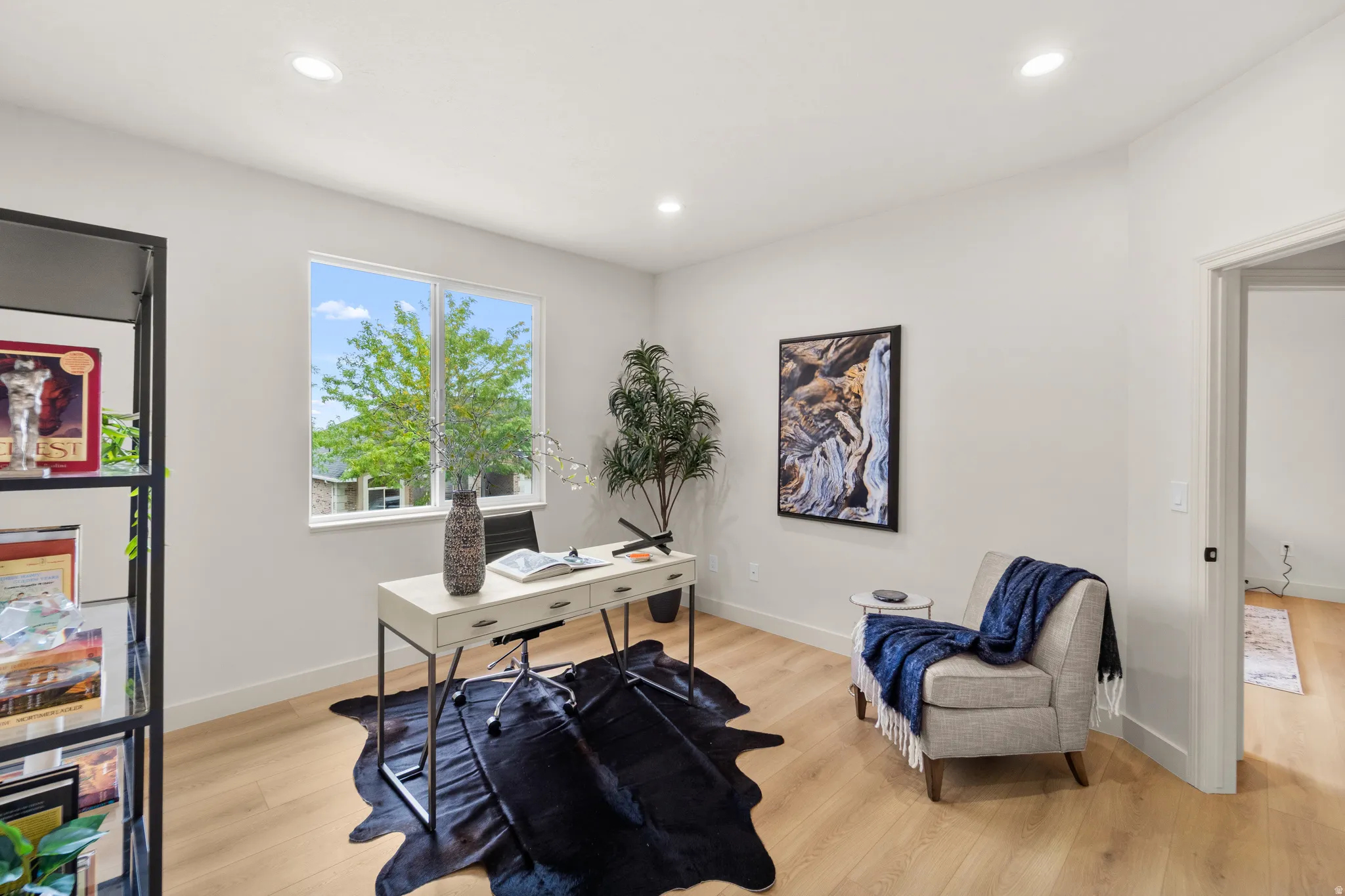 Recessed ceiling lighting, wood-finish flooring, and a large window