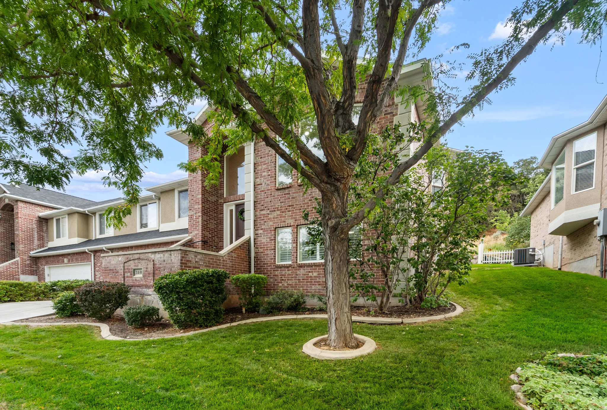 Brick facade with a multi-level design, white trim, and a prominent front entry