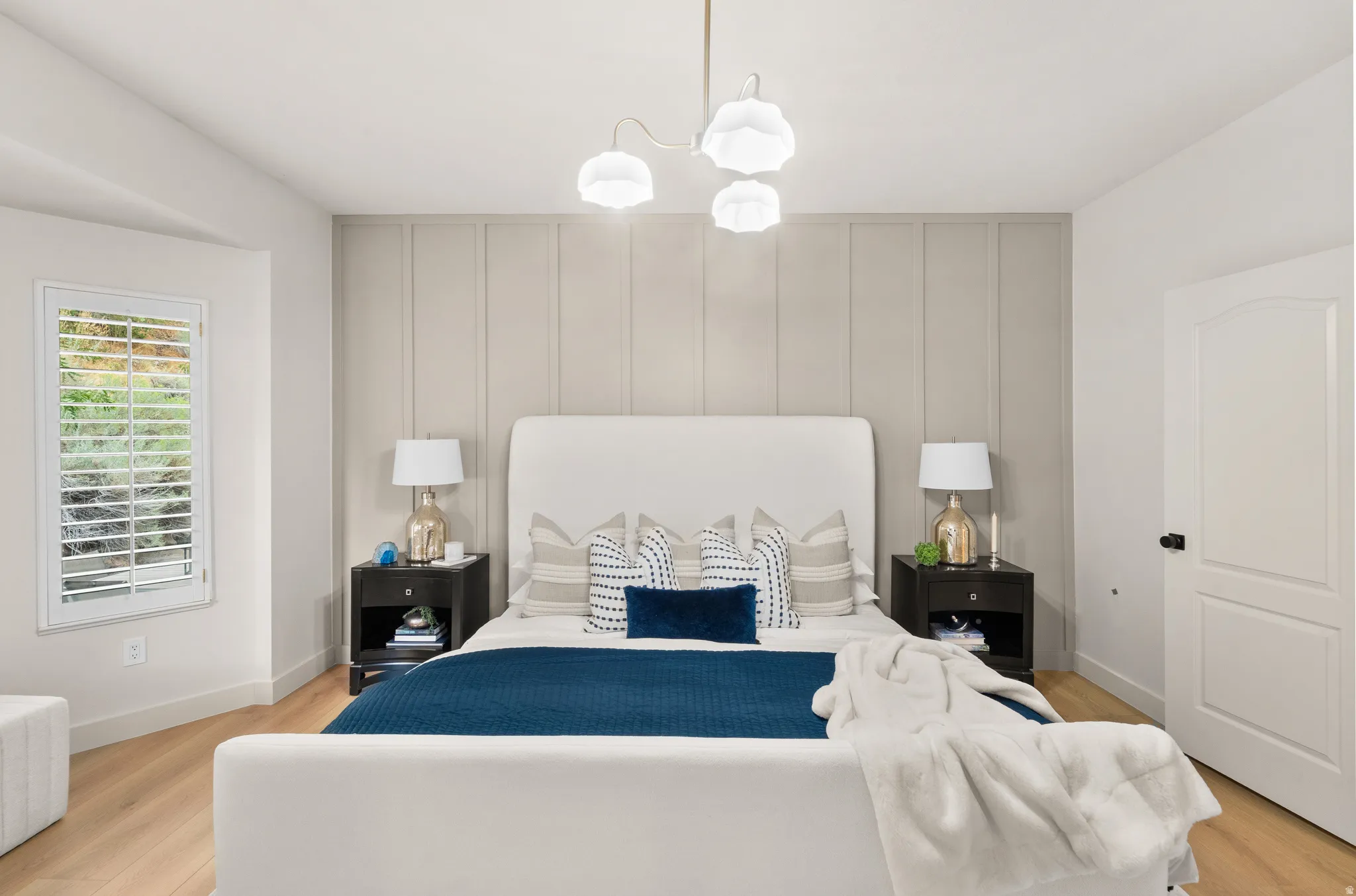 Light wood-finish flooring with a panel accent wall