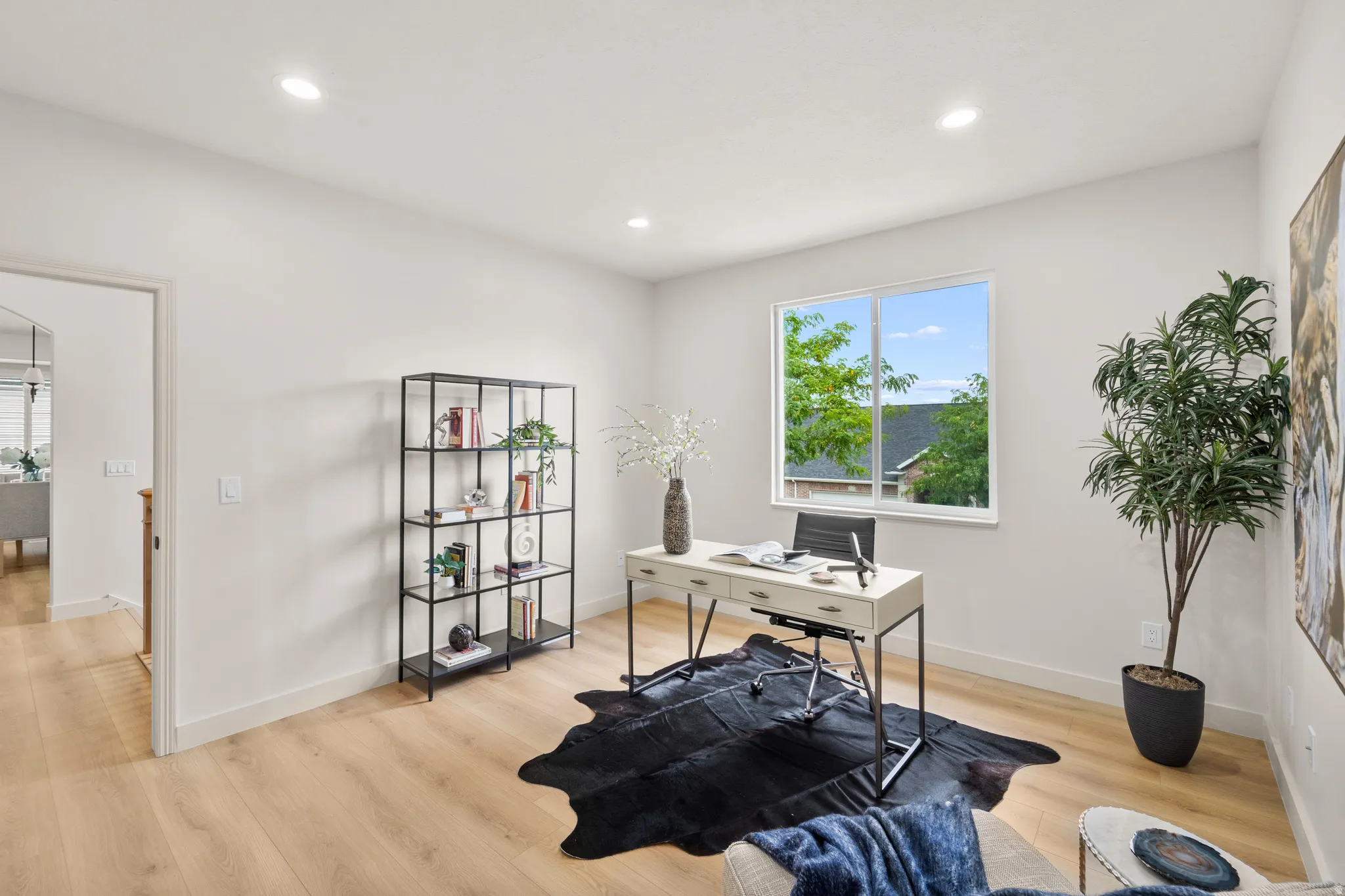 Recessed lighting illuminates wood-finish flooring